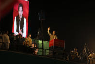 Pakistani opposition leader Imran Khan, center, addresses his party supporters during a rally in Peshawar, Pakistan, Tuesday, Sept. 6, 2022. Since he was toppled by parliament five months ago, former Prime Minister Imran Khan has demonstrated his popularity with rallies that have drawn huge crowds and signaled to his rivals that he remains a considerable political force. (AP Photo/Mohammad Sajjad)