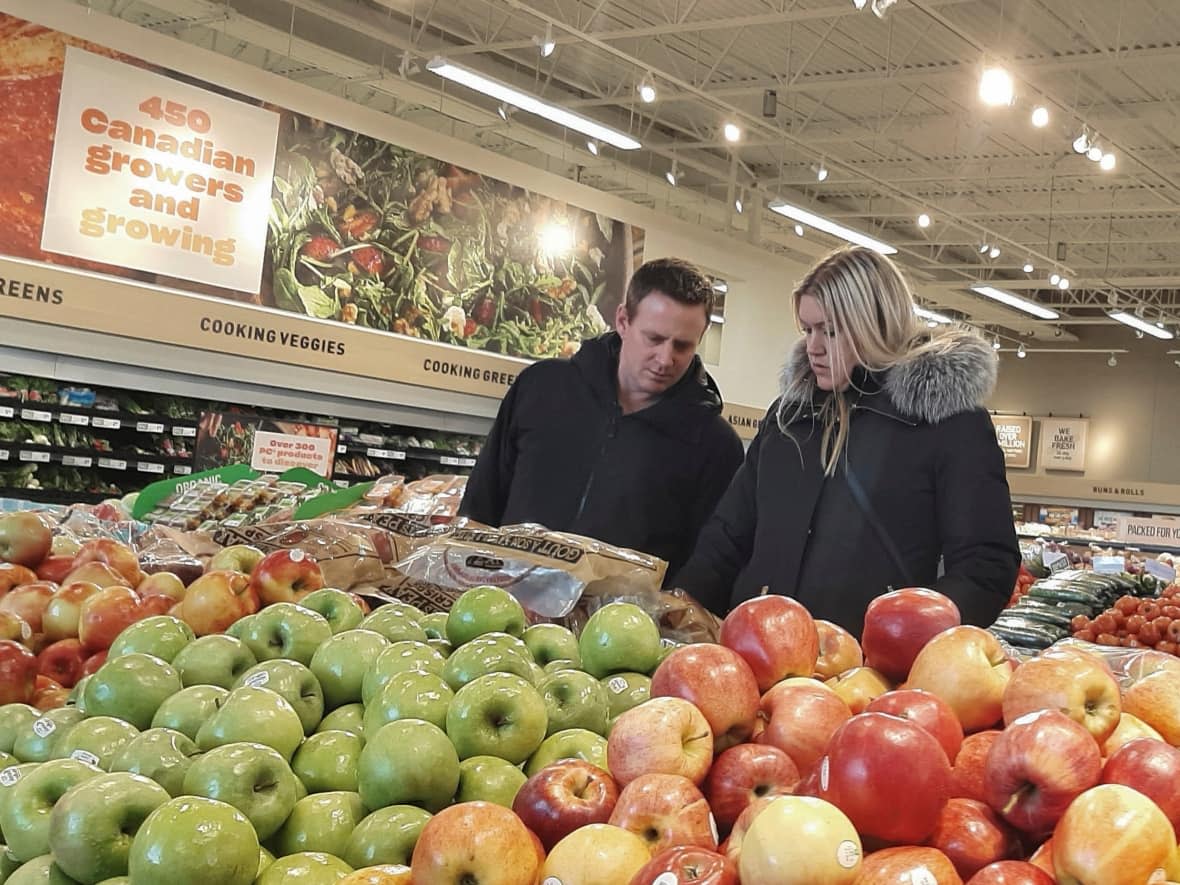 People shop for fruit and vegetables at a supermarket in Ottawa earlier this week. (Patrick Doyle/Reuters - image credit)