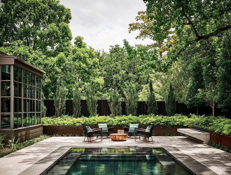 Lush landscaping surrounds the pool.