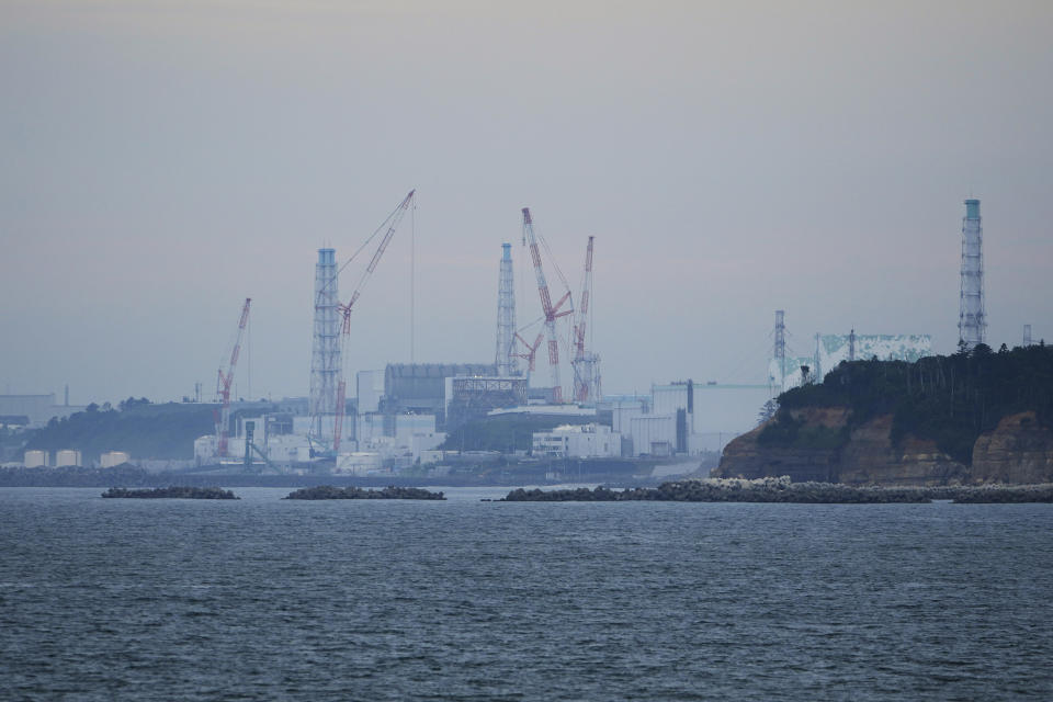 The Fukushima Daiichi nuclear power plant, operated by Tokyo Electric Power Company Holdings, also known as TEPCO, is seen from the nearby Ukedo fishing port in Namie town, northeastern Japan, Friday, July 14, 2023. (AP Photo/Hiro Komae)