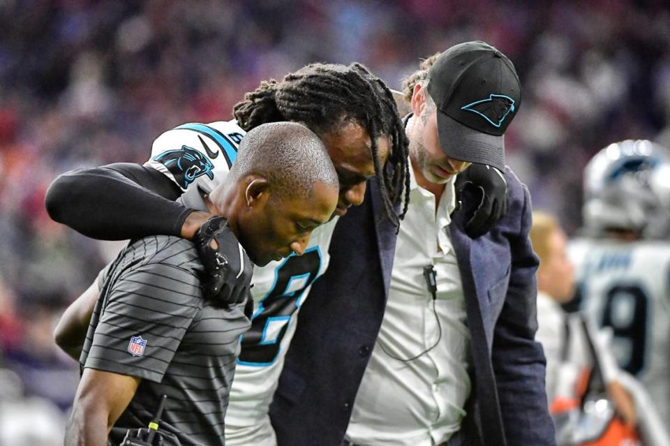 Carolina Panthers cornerback Jaycee Horn (8) is helped off the field after an injury during the second half of an NFL football game against the Houston Texans Thursday, Sept. 23, 2021, in Houston.