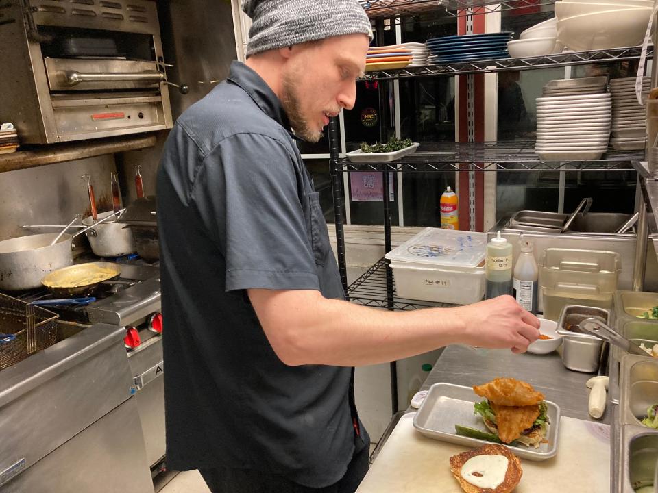 Executive chef Kyle Miller prepares a fish sandwich Jan. 4, 2024 at Lost Nation Brewing in Morrisville.