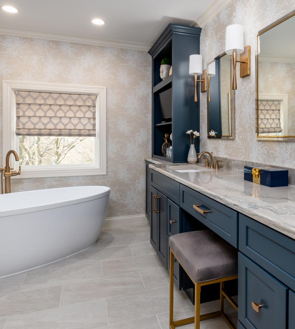 New cabinets were added throughout and include a vanity area, a built-in electric plug-in drawer for a hairdryer, updated hardware, and shelving to accommodate a TV.