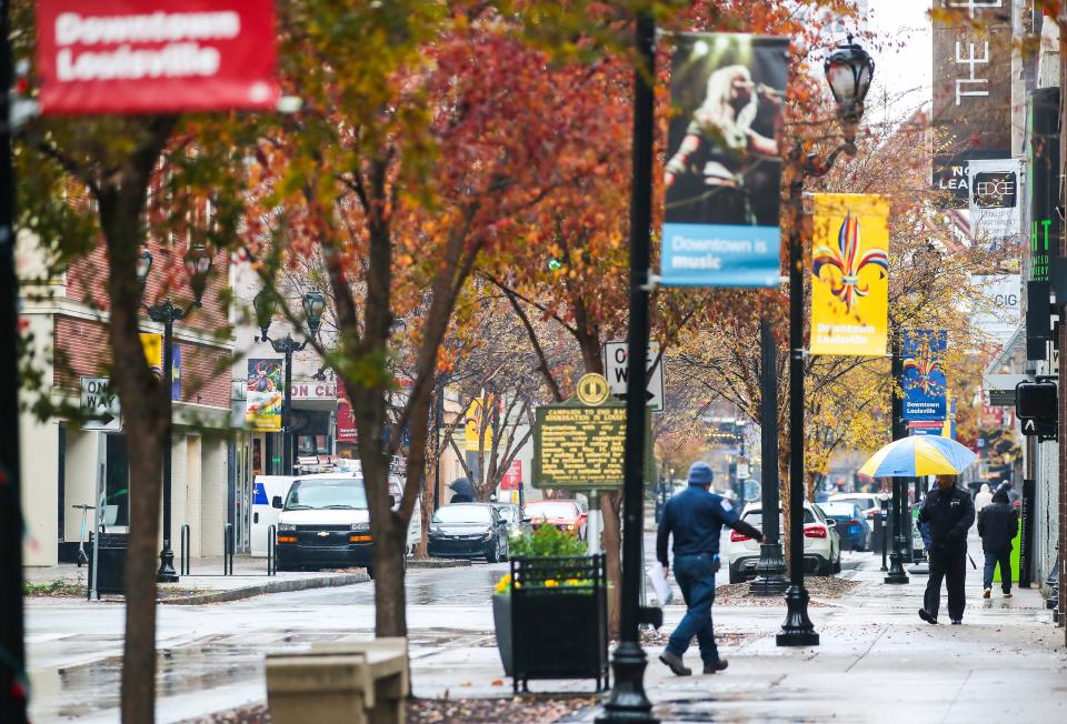 People walk along 4th Street on a rainy December morning recently. Dec. 5, 2023
