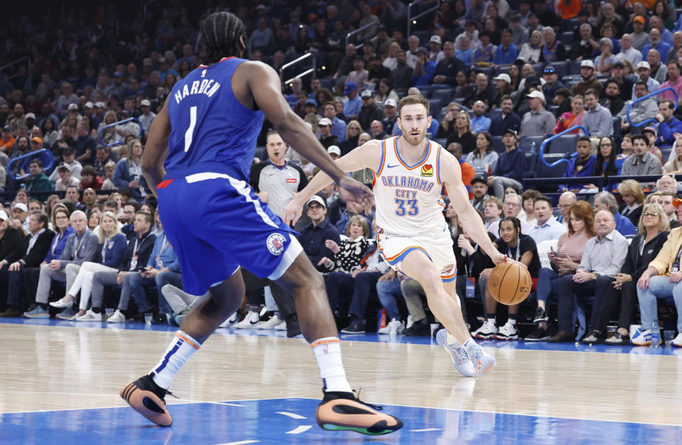 Feb 22, 2024; Oklahoma City, Oklahoma, USA; Oklahoma City Thunder forward Gordon Hayward (33) dribbles the ball down the court against LA Clippers guard James Harden (1) during the second quarter at Paycom Center. Mandatory Credit: Alonzo Adams-USA TODAY Sports