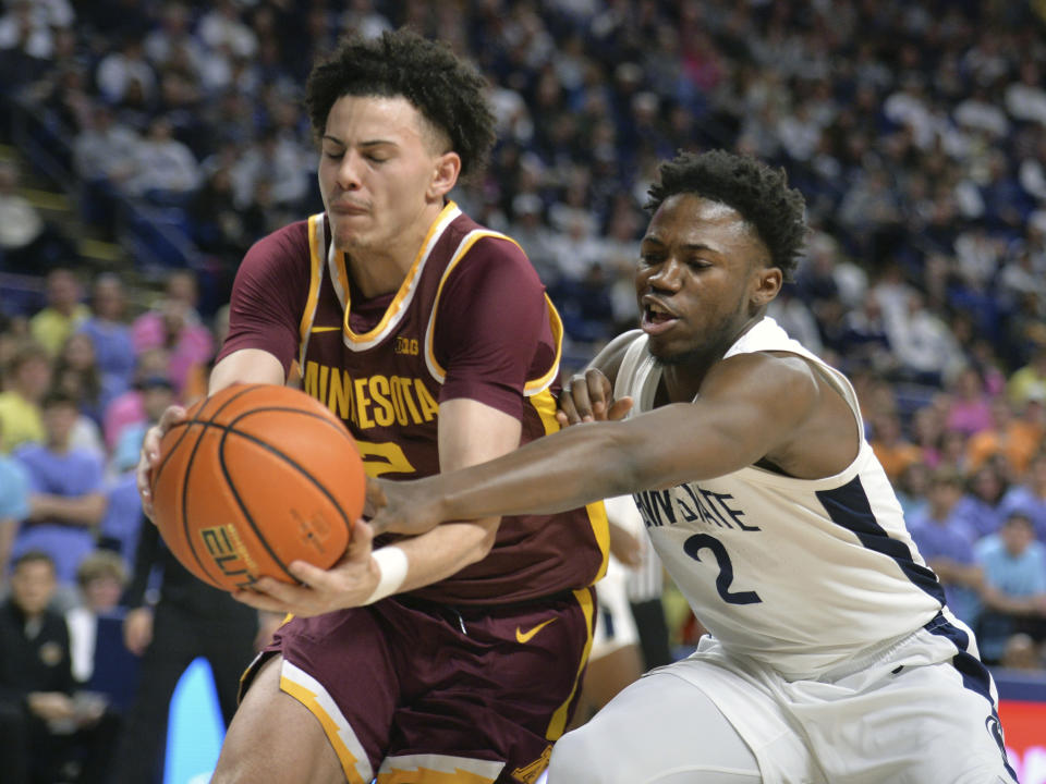 Minnesota's Mike Mitchell Jr.,left, and Penn State's D'Marco Dunn,right, go after an inbound pass during the first half of an NCAA college basketball game Saturday, Jan. 27, 2024, in State College, Pa. (AP Photo/Gary M. Baranec)