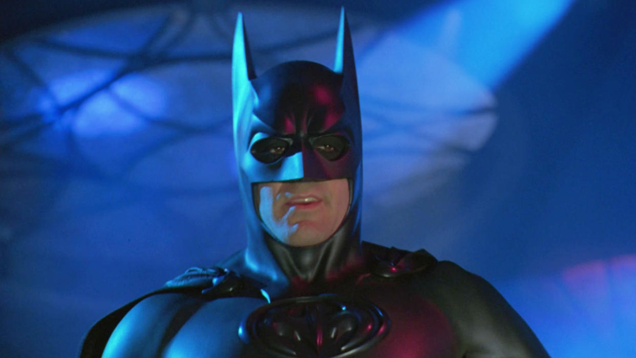  George Clooney donning the Batman Cowl in Batman & Robin. 