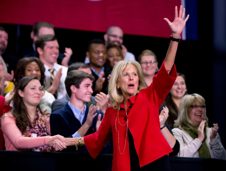 Jill Biden waves to the audience as she arrives to speak at Pellissippi State Community College, Friday, Jan. 9, 2015, in Knoxville, Tenn., about new initiatives to help more Americans go to college and get the skills they need to succeed. (AP Photo/Carolyn Kaster)