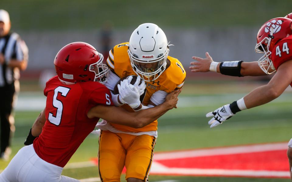 Kickapoo's Branson Davis carries the ball during a jamboree game with the Ozark Tigers and Nixa Eagles at Ozark on Friday, Aug. 18, 2023.