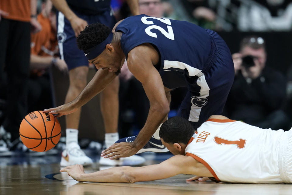 Penn State guard Jalen Pickett (22) fights for a loose ball with Texas forward Dylan Disu (1) in the first half of a second-round college basketball game in the NCAA Tournament, Saturday, March 18, 2023, in Des Moines, Iowa. (AP Photo/Charlie Neibergall)
