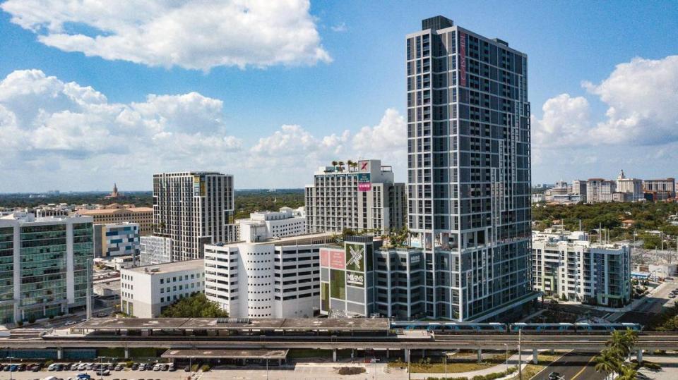 The new Cascade apartment tower rises 37 stories at the Douglas Road Metrorail Station near U.S. 1, with the lower companion CORE Link residential building to its left, at center. Just to CORE’s left is the new Avalon Coral Gables apartment building. The Modera Coral Gables apartments sit behind Cascade.