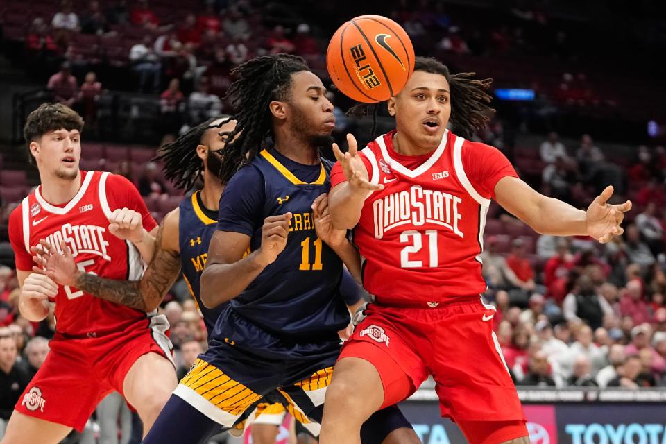 Nov 15, 2023; Columbus, OH, USA; Ohio State Buckeyes forward Devin Royal (21) loses control of the ball while being guarded by Merrimack College Warriors forward Bryan Etumnu (11) during the second half of the NCAA men’s basketball game at Value City Arena. Ohio State won 76-52.