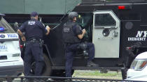 <p>In this image taken from video, New York Police Department Emergency Services officers stand by their armored vehicle outside Bronx Lebanon Hospital in New York, after a gunman opened fire there on Friday, June 30, 2017. (AP Photo/Joseph Frederick) </p>