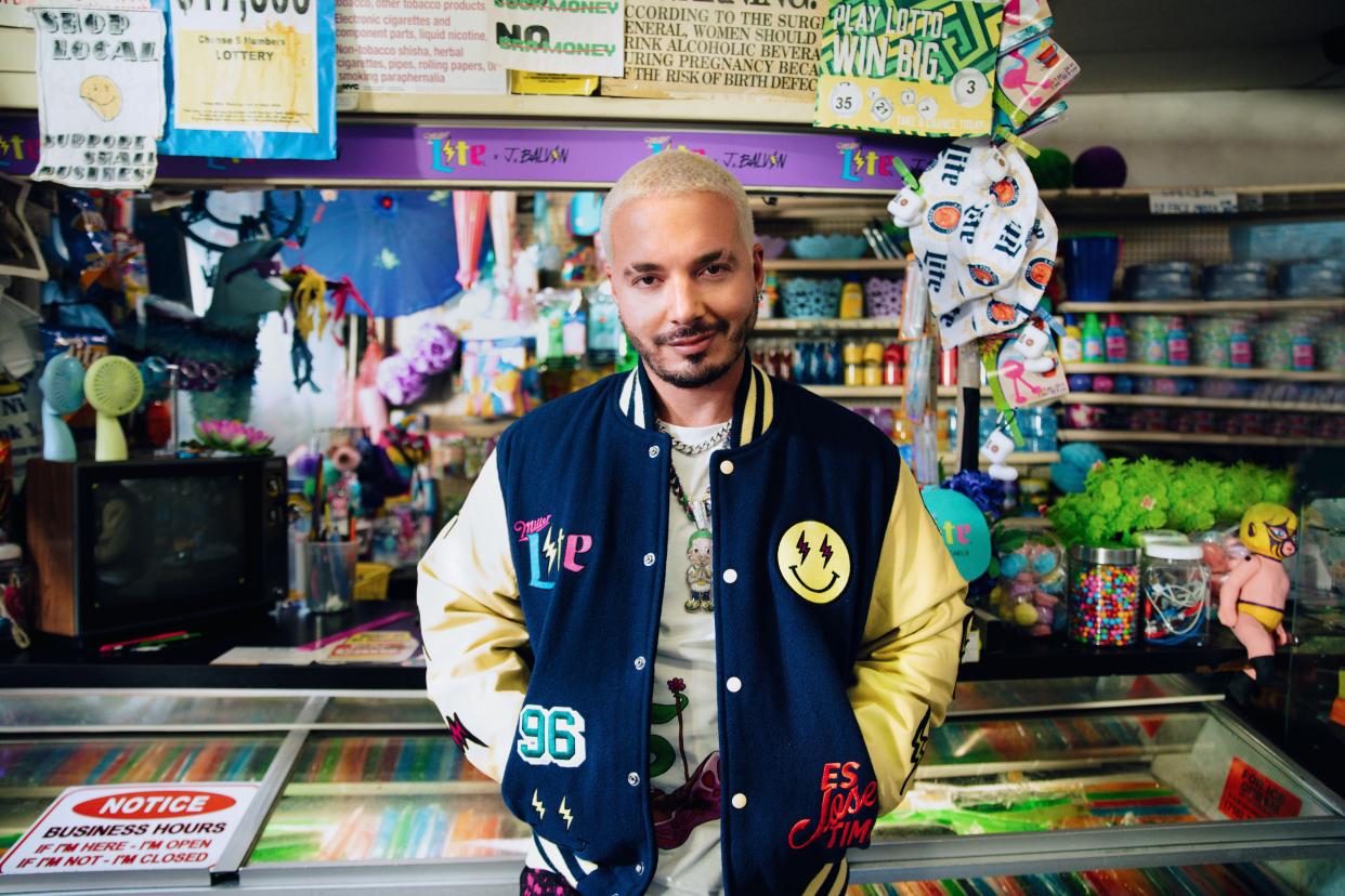 J Balvín sports a varsity jacket from his upcoming collaboration with Miller Lite dubbed BodegaWear.