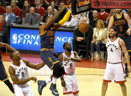 May 21, 2016; Toronto, Ontario, CAN; Cleveland Cavaliers forward LeBron James dunks a basket over Toronto Raptors center Bismack Biyombo (8) and forwards DeMarre Carroll (5) and Luis Scola (4) in game three of the Eastern conference finals of the NBA Playoffs at Air Canada Centre. Mandatory Credit: Dan Hamilton-USA TODAY Sports