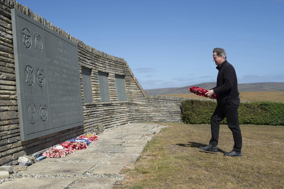 Foreign Secretary Lord David Cameron visits San Carlos Cemetery on the Falkland Islands, during his high-profile visit to demonstrate they are a "valued part of the British family" amid renewed Argentinian calls for talks on their future, in Stanley, Falkland Islands, Britain, on Monday Feb. 19, 2024. (Stefan Rousseau/PA via AP)