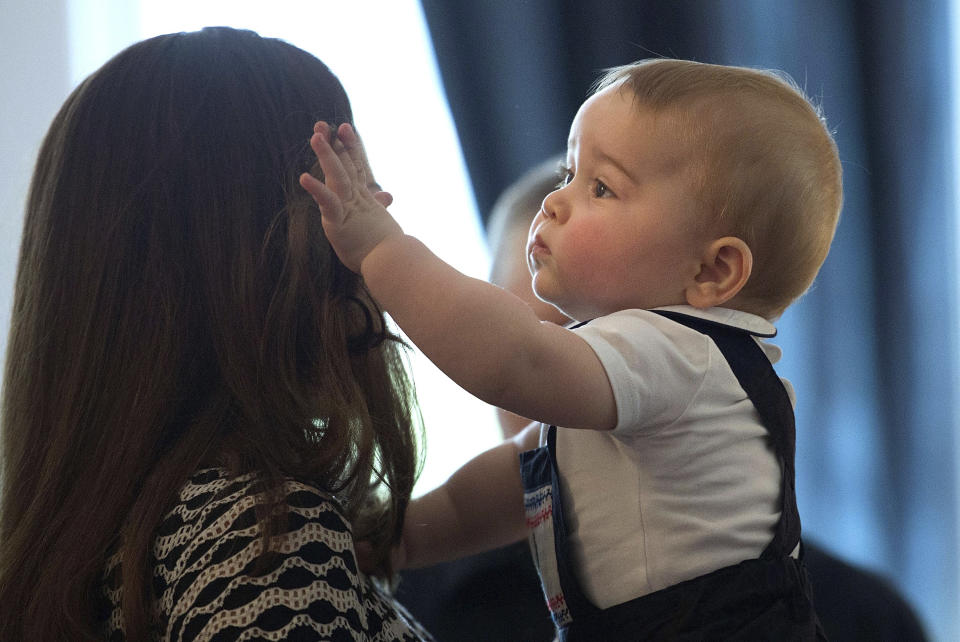 Britain's Kate, the Duchess of Cambridge, holds Prince George during a visit to Plunket nurse and parents group at Government House in Wellington, New Zealand, Wednesday, April 9, 2014. Plunket is a national not-for-profit organization that provides care for children and families in New Zealand. Prince William, Kate and their son, Prince George, are on a three-week tour of New Zealand and Australia. (AP Photo/Marty Melville, Pool)