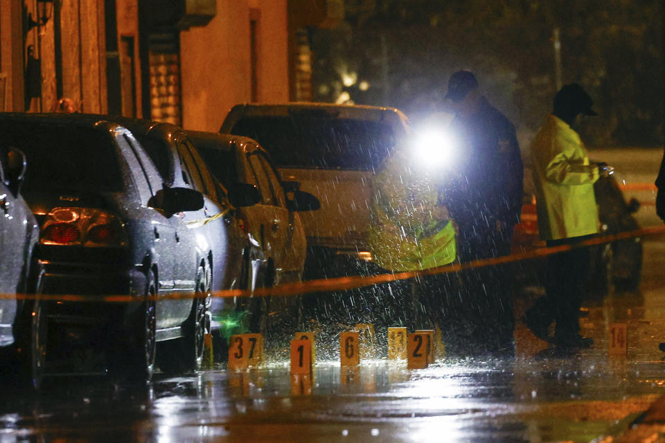 Police and crime scene investigators respond to multiple people shot at in Philadelphia, on Tuesday, Nov. 21, 2023. Police investigation into the shooting of seven men, including two who died, continued Wednesday but authorities said no arrests have been made. (Steven M. Falk/The Philadelphia Inquirer via AP)