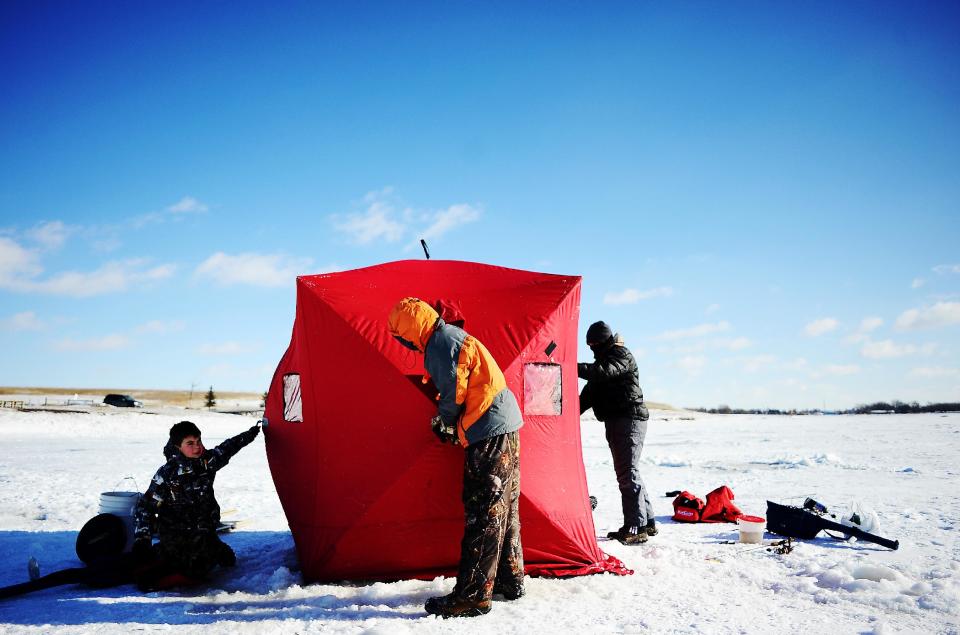 Despite subzero wind chill temperatures, from left, Josh Anderson, 12, Jake Anderson, 14, and Marshal McGovern, 13, all of Sioux Falls, S.D., set up a portable fish house before doing some ice fishing at Family Park in Sioux Falls on Sunday, Jan. 5, 2014. Monday’s temperatures in Sioux Falls are expected to see a low of minus 20 degrees, an expected high of minus 13 degrees and wind chills possibly dipping below minus 40, according to National Weather Service Meteorologist Philip Schumacher. According to National Weather Service records, the last time Sioux Falls saw wind chills approaching minus 50 was in 1997. (AP Photo/Argus Leader, Joe Ahlquist)