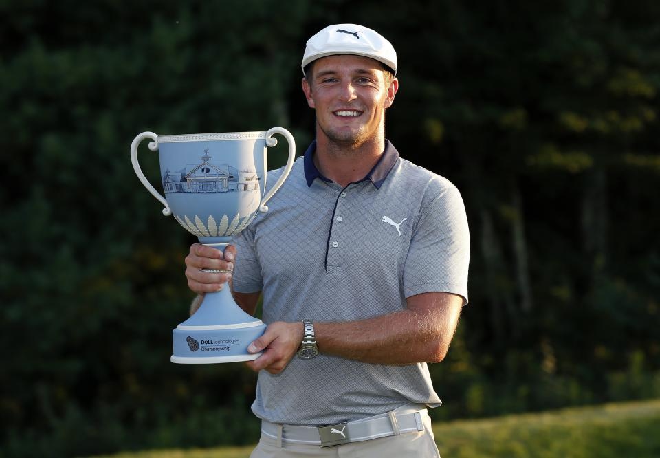 Bryson DeChambeau holds the trophy after winning the Dell Technologies Championship golf tournament at TPC Boston in Norton, Mass., Monday, Sept. 3, 2018. (AP Photo/Michael Dwyer)