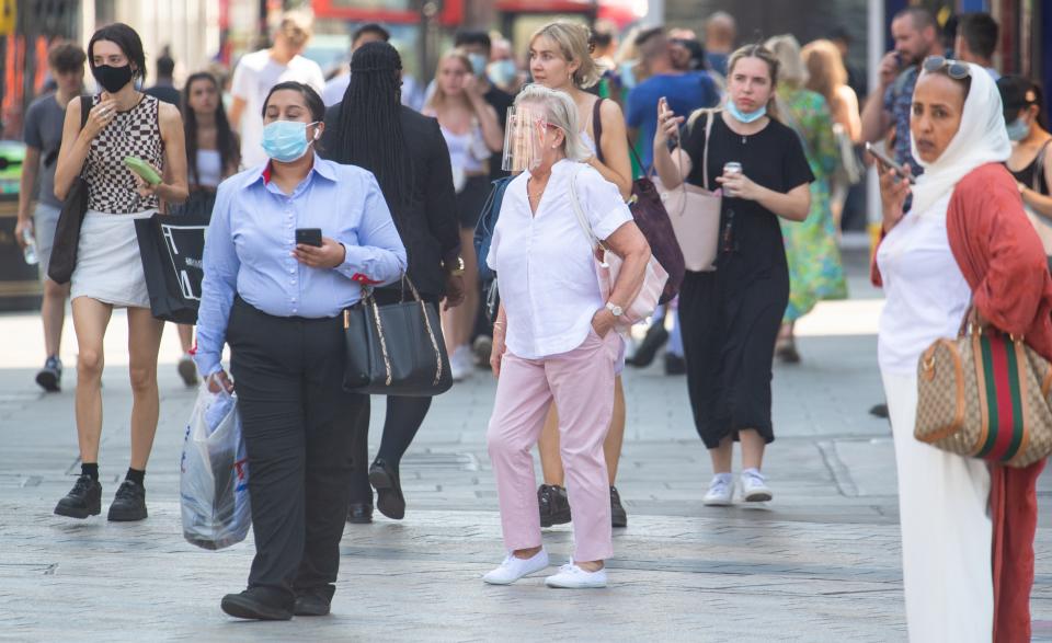 People wearing face masks in central London, after the final coronavirus legal restrictions were lifted in England (Dominic Lipinski/PA) (PA Wire)