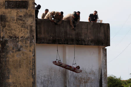 FILE PHOTO - Military police and firefighters rescue an injured inmate to transport him to hospital during an uprising at Alcacuz prison in Natal, Rio Grande do Norte state, Brazil January 20, 2017. REUTERS/Nacho Doce/File photo