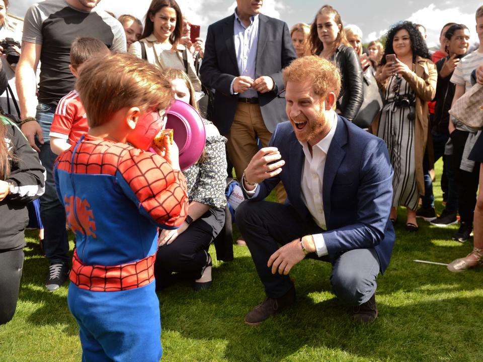 Prince Harry with a young boy dressed as Spider Man