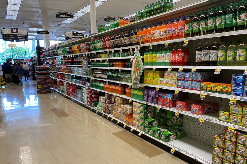 FILE PHOTO: Customers wait in line to check out inside Kroger Co.'s Ralphs supermarket amid fears of the global growth of coronavirus cases, in Los Angeles