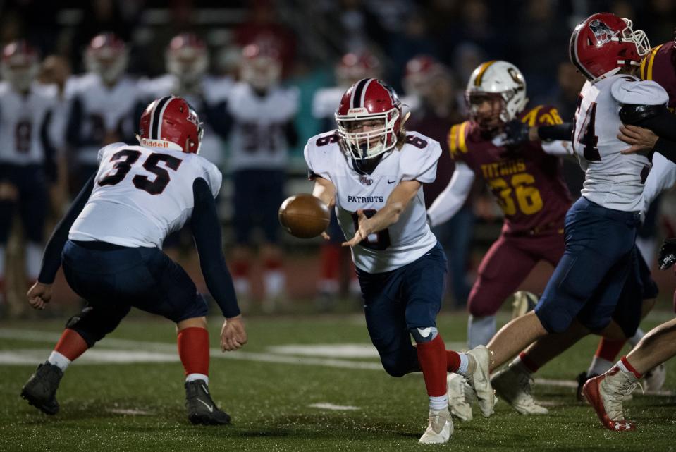 Heritage Hills' Camden Schipp (6) tosses the ball as the Gibson Southern Titans play the Heritage Hills Patriots for the IHSAA Class 3A football sectional championship in Fort Branch, Ind., Friday evening, Nov. 5, 2021. 