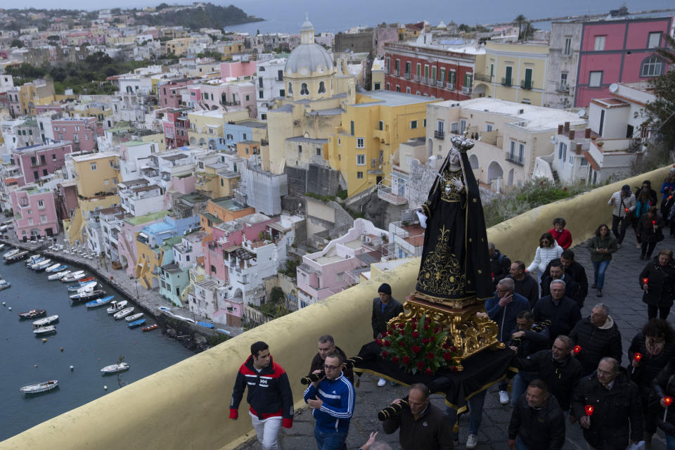 Faithful carry a statue of the Madonna known as the Addolorata, before the start of a procession the in Procida Island, Italy, early Friday, March 29, 2024. Italy is known for the religious processions that take over towns big and small when Catholic feast days are celebrated throughout the year. But even in a country where public displays of popular piety are a centuries-old tradition, Procida's Holy Week commemorations stand out. (AP Photo/Alessandra Tarantino)