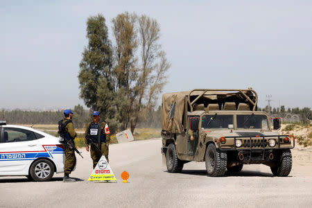 Israeli military vehicles block a road near the border between Israel and the Gaza Strip, Israel March 18, 2018. REUTERS/Amir Cohen