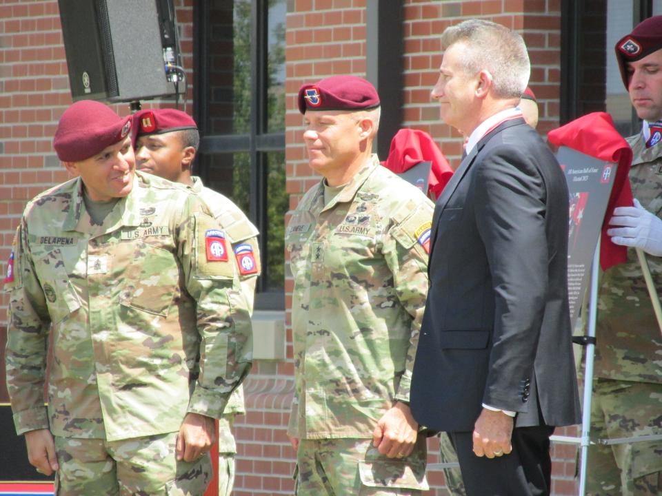 Retired Gen. John Nicholson Jr., far right, is congratulated by  Maj. Gen. Christopher LaNeve,  second from right and Command Sgt. Maj. Randolph Delapena, far left, after being inducted into the 82nd Airborne Division Hall of Fame during a ceremony Wednesday, May 24, 2023, at Fort Bragg.