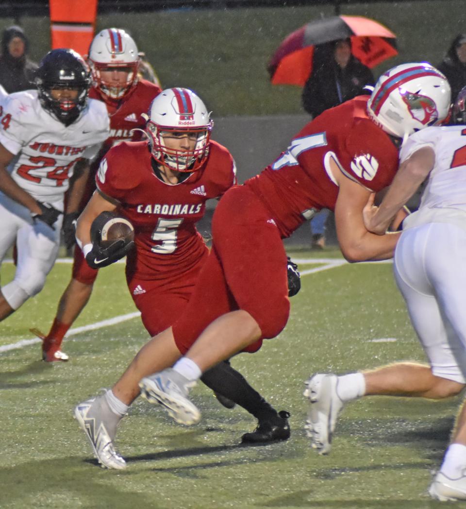 Coldwater's Kendall Austin looks for running room behind his blockers versus Northwest on Friday