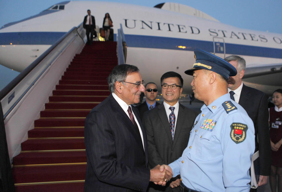 U.S. Secretary of Defense Leon Panetta, left, shakes hands with China's Chief of the General Staff Gen. Ma Xiao Tian as U.S. Ambassador to China Gary Locke, center, looks on after Panetta's arrival at Beijing International Airport Monday, Sept. 17, 2012. Panetta is on his third trip to Asia in 11 months, reflecting the Pentagon's ongoing shift to put more military focus on the Asia-Pacific. (AP Photo/Larry Downing, Pool)