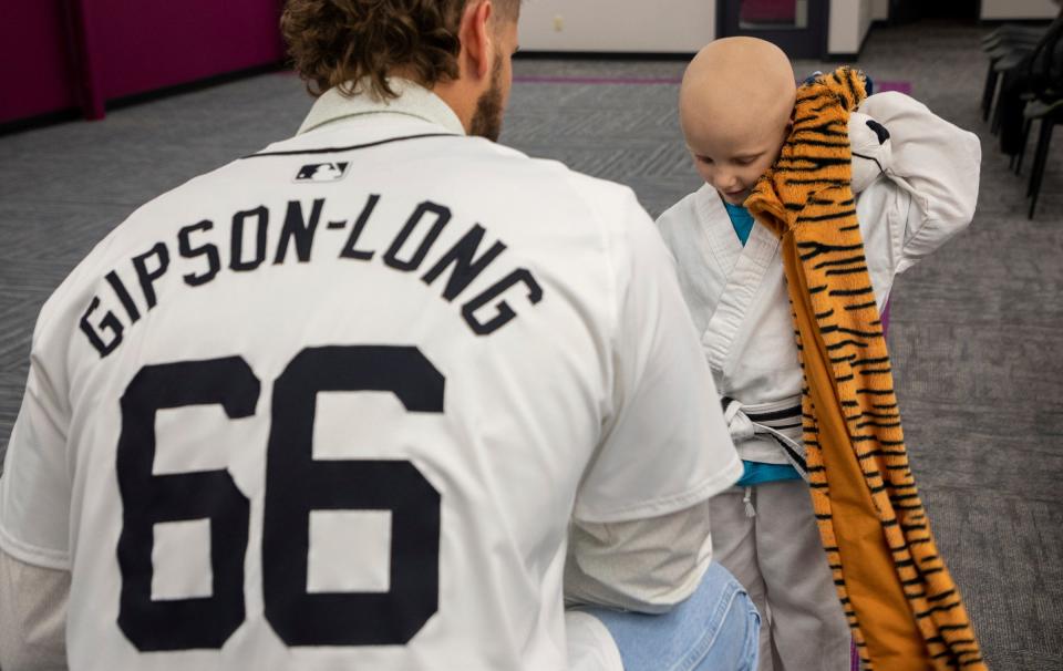 Tigers pitcher Sawyer Gipson-Long gives a Tigers hat to 5-year-old Cailen Vela inside The Charach Global Kids Kicking Cancer Center in Southfield on Wednesday, Dec. 6, 2023.