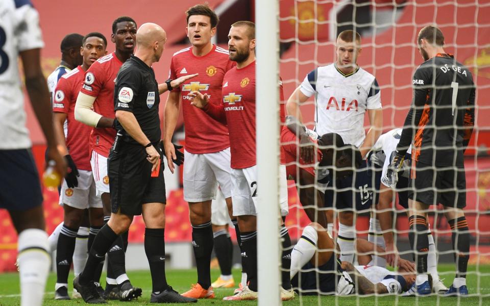 Manchester United's Anthony Martial is shown a red card by referee Anthony Taylor after clashing with Tottenham Hotspur's Erik Lamela