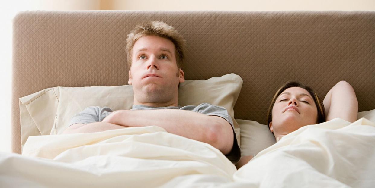 frustrated man and sleeping woman