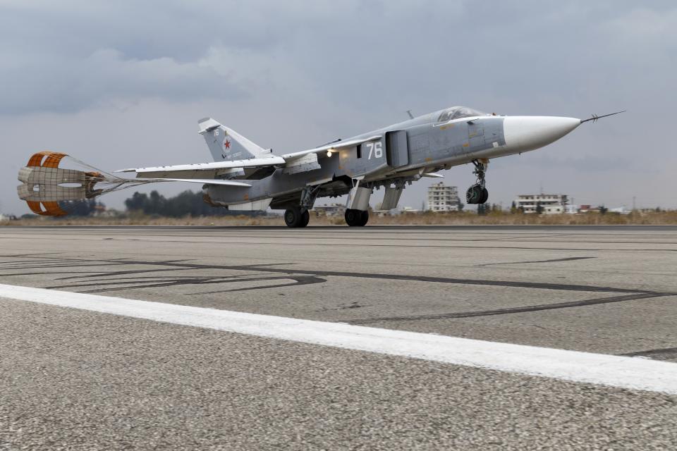 FILE - In this Wednesday, Dec. 16, 2015 file photo and provided by the Russian Defense Ministry Press Service, a Russian Su-24 bomber lands at Hemeimeem air base in Syria. The Russian military says its warship has fired warning shots and a warplane dropped bombs to force a British destroyer from Russia's waters near Crimea in the Black Sea. The incident on Wednesday June 23, 2021, marks the first time since the Cold War era when Moscow used live ammunition to deter a NATO warship, reflecting soaring Russia-West tensions. (Russian Defense Ministry Press Service via AP, File)