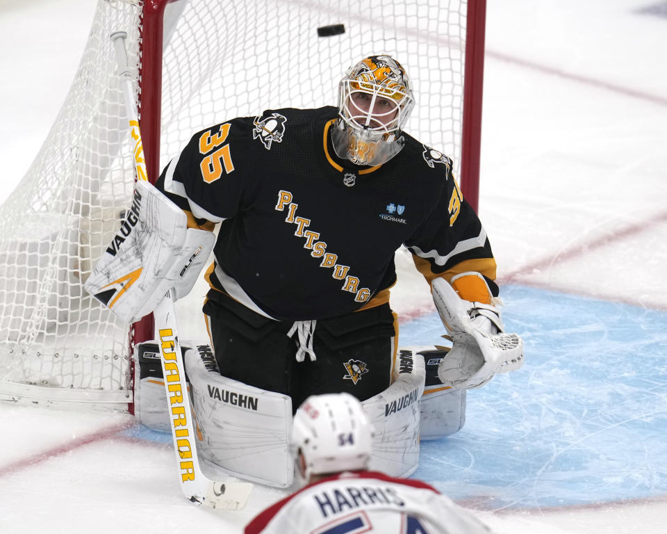 Pittsburgh Penguins goaltender Tristan Jarry (35) keeps his eye on a shot by Montreal Canadiens' Jordan Harris (54) during the first period of an NHL hockey game in Pittsburgh, Thursday, Feb. 22, 2024. (AP Photo/Gene J. Puskar)