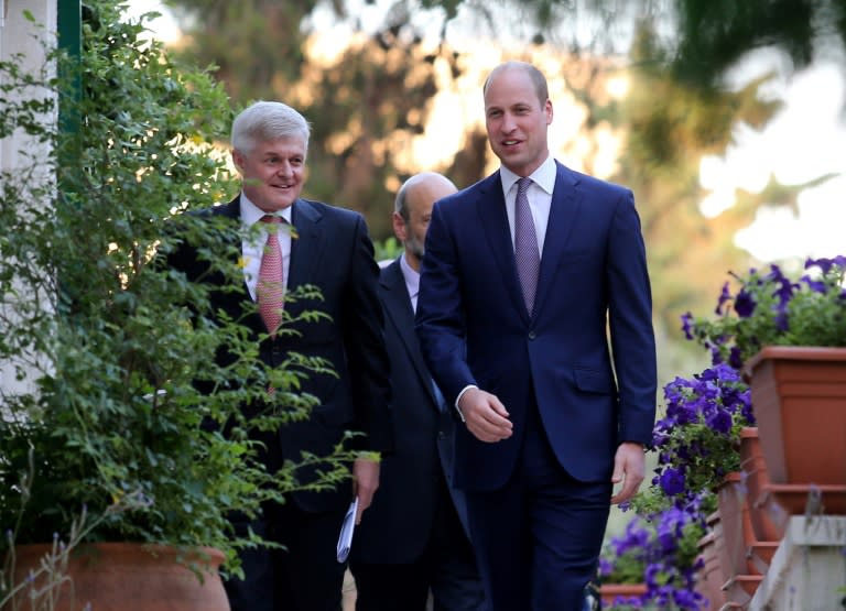 Britain's Prince William attends a birthday party in honour of his grandmother, Queen Elizabeth II, at the residence of the British ambassador Edward Oakden's (L) house in the Jordanian capital Amman on 24 June, 2018