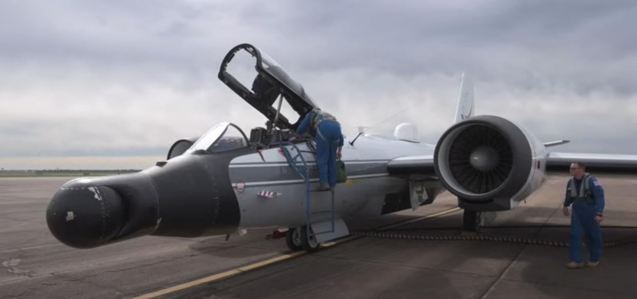  A ground crew services a jet airplane. 