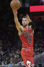 Chicago Bulls guard Zach LaVine (8) passes the ball after driving through the lane during the first half of an NBA basketball game against the Orlando Magic, Friday, Nov. 26, 2021, in Orlando, Fla. (AP Photo/Phelan M. Ebenhack)