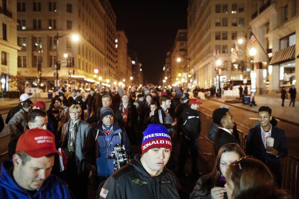 Spectators wait in line to pass through security checkpoints of President-elect Donald Trump's inauguration, Friday, Jan. 20, 2017, in Washington. (AP Photo/John Minchillo)