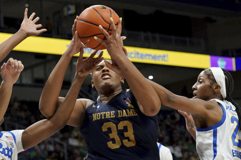 Notre Dame center Lauren Ebo (33) pulls down a rebound against Pittsburgh forward Maliyah Johnson, right, during the first half of an NCCA college basketball game in Pittsburgh, Sunday, Feb. 19, 2023. (AP Photo/Matt Freed)