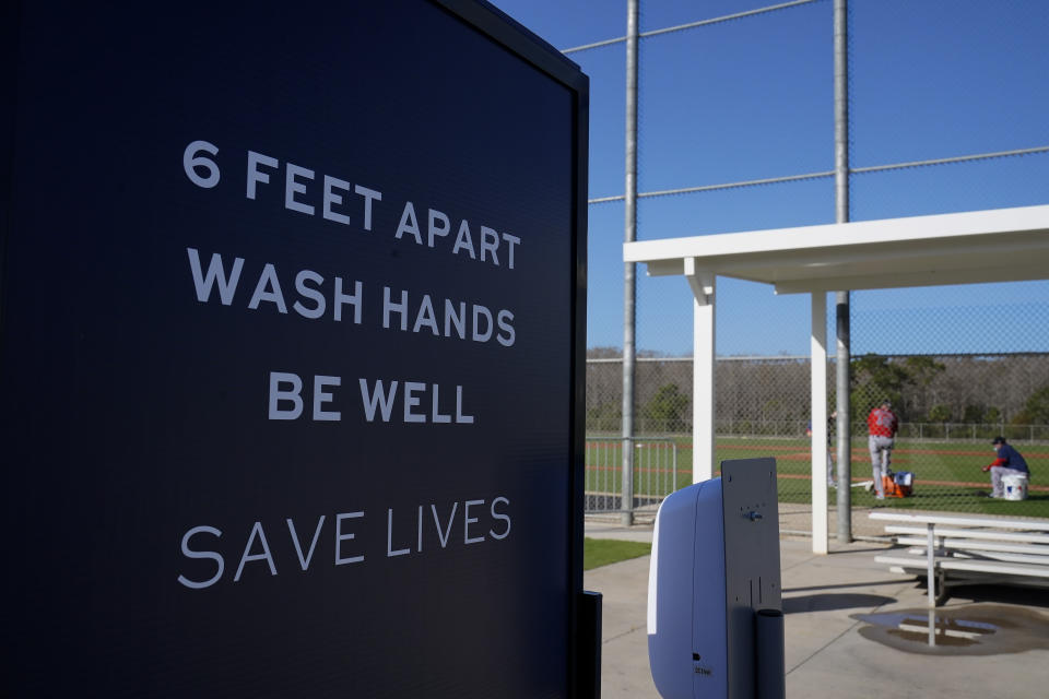 Signs are posted during a Boston Red Sox spring training baseball practice on Monday, Feb. 22, 2021, in Fort Myers, Fla. (AP Photo/Brynn Anderson)