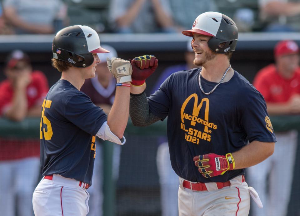 The North’s Drew Bryant, left, of Brimfield, congratulates teammate Frank Kelch, also of Brimfield, after he hit a home run during the small schools game of the 30th annual McDonald’s All-Star series Tuesday, June 22, 2021 at Dozer Park in Peoria.