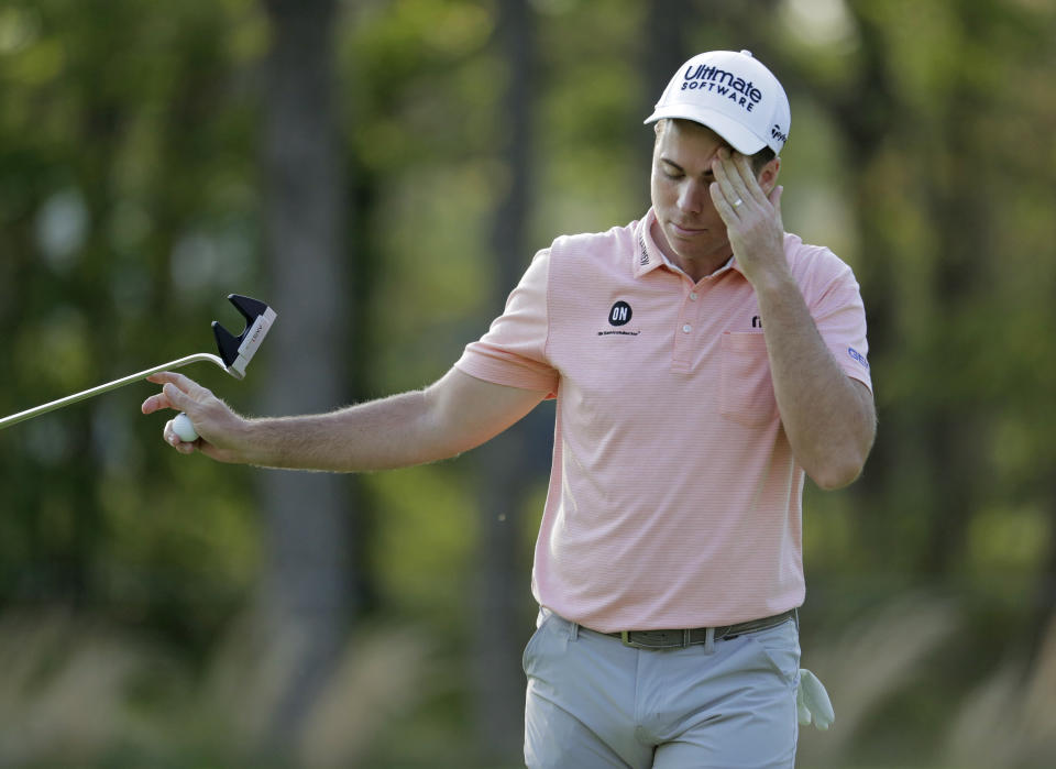 Luke list hands his putter to his caddie after putting on the seventh green during the second round of the PGA Championship golf tournament, Friday, May 17, 2019, at Bethpage Black in Farmingdale, N.Y. (AP Photo/Julio Cortez)