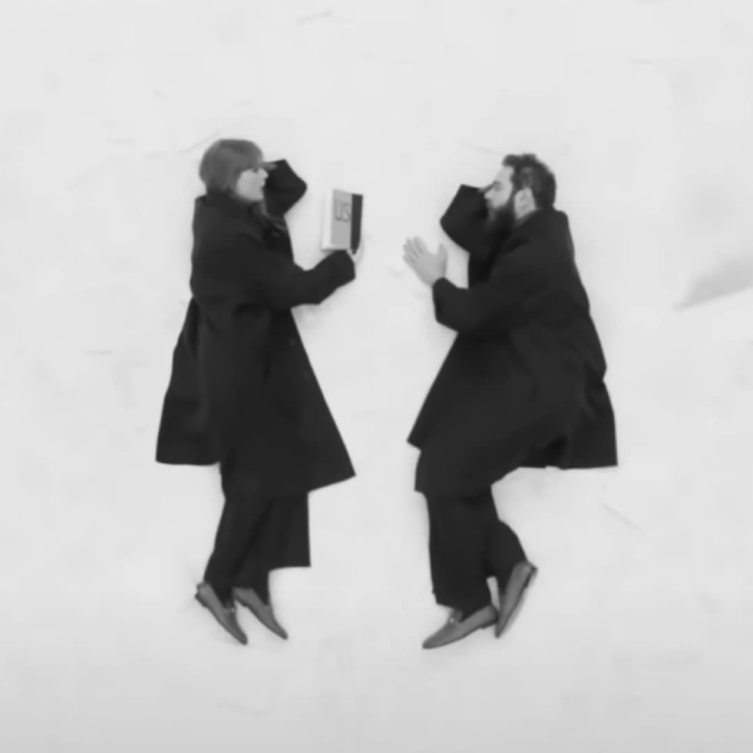  Taylor Swift and Post Malone laying on the ground wearing matching Gucci loafers. 