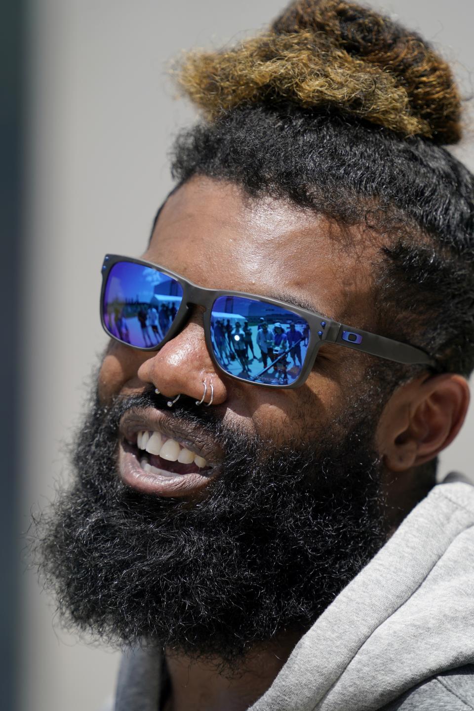 Dallas Cowboys running back Ezekiel Elliott responds to a question as he speaks with members of the media after a workout at the team's NFL football training facility in Frisco, Texas, Wednesday, Aug. 25, 2021. (AP Photo/Tony Gutierrez)