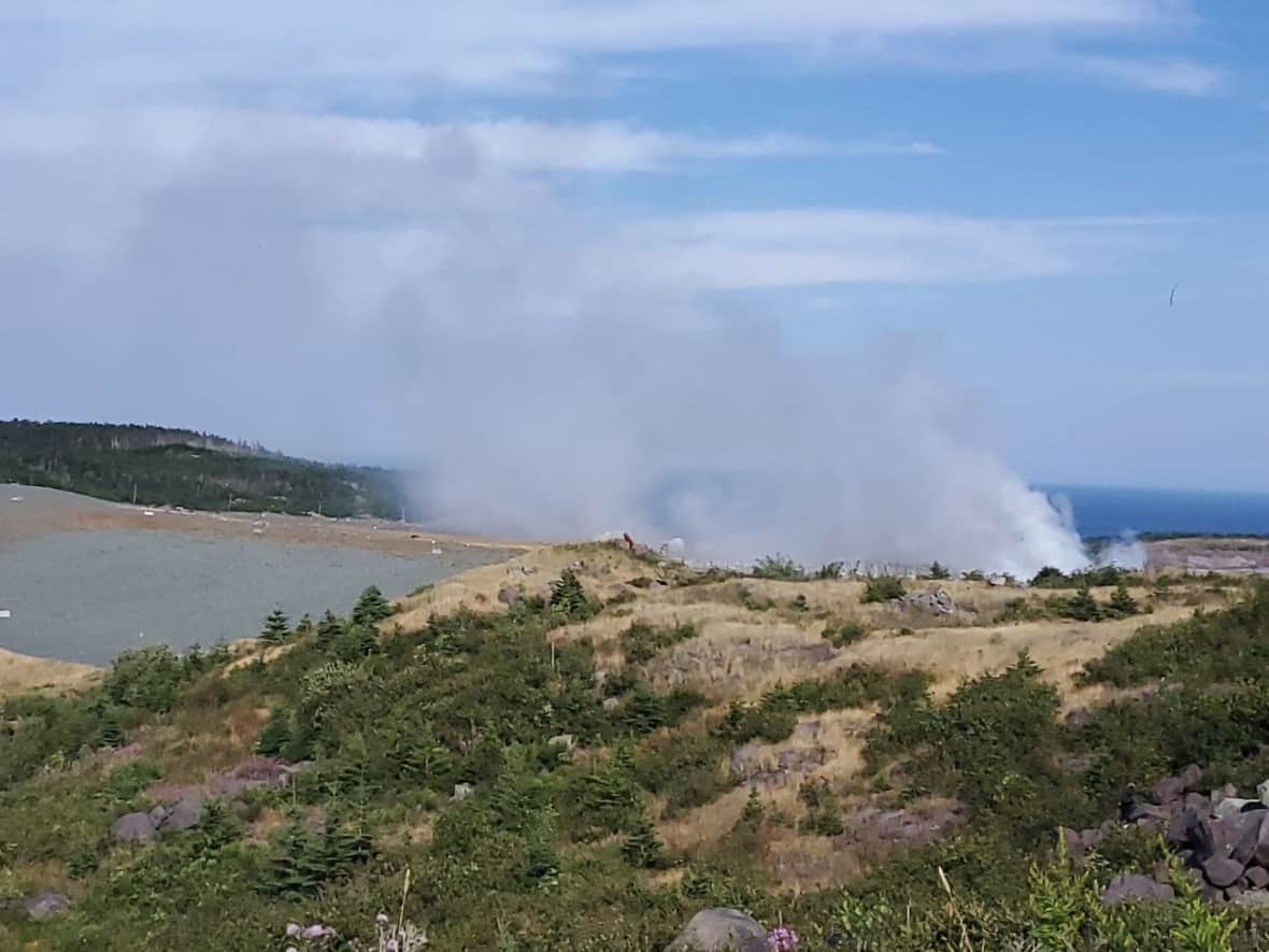 A fire at the Robin Hood Bay landfill facility continued to burn throughout Sunday afternoon. (Andrea McGuire/CBC - image credit)